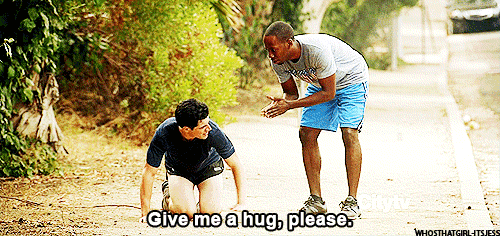 two men are kneeling on the ground and one of them is asking for a hug