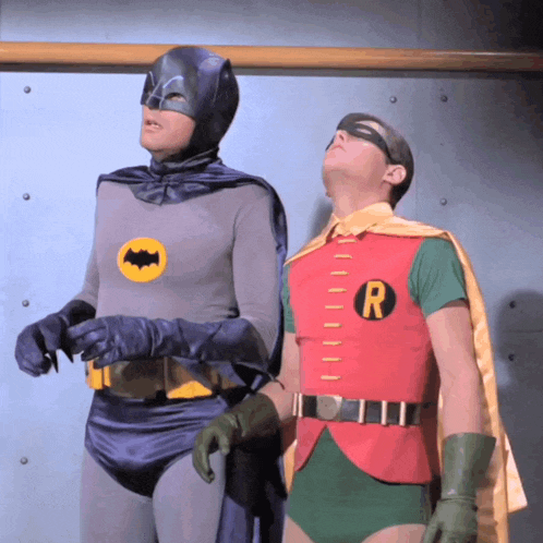 a man in a batman costume and a man in a robin costume