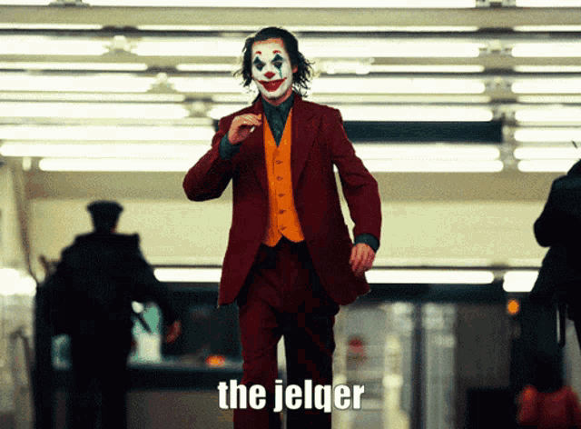 a man in a joker costume is standing in a dark room