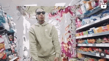 a man wearing sunglasses is standing in a store .