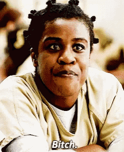 a woman in a yellow shirt with the word bitch on it