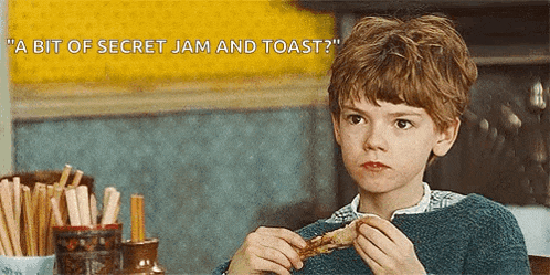 a young boy is sitting at a table eating a piece of bread with the caption " a bit of secret jam and toast "