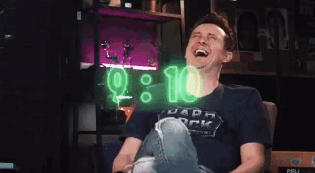 a man is laughing while wearing a shirt that says vader rock