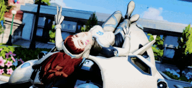 a woman laying on top of a white vehicle with the letter a on it