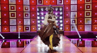 a woman in a costume is walking down a runway .
