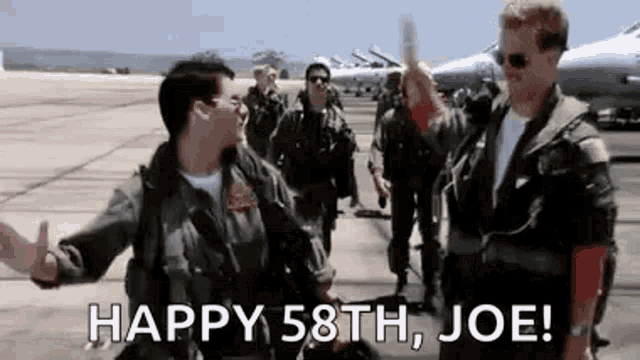 a group of men in military uniforms are standing next to each other on an airport tarmac .