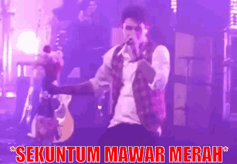 a man singing into a microphone with the words " sekuntum mawar merah " written above him