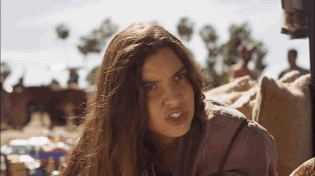 a woman with long hair making a funny face with her mouth open