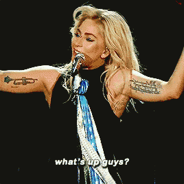a woman singing into a microphone with the words " what 's up guys " on the bottom