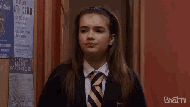 a girl stands in front of a sign that says ' academy bath club ' on it