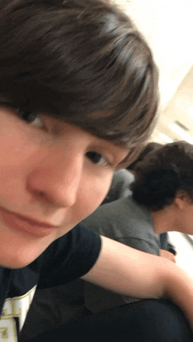 a close up of a person 's face with a t-shirt that says ' a ' on it