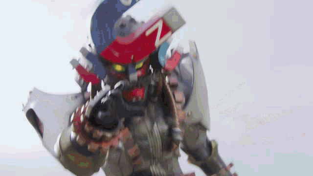 a robot is holding a large magnet with the letter z on it 's head