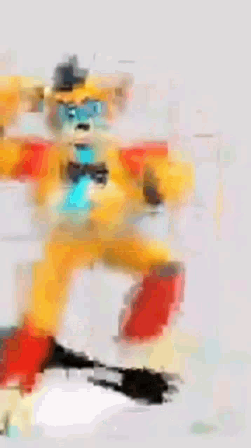 a blurred image of a cartoon character wearing a hat