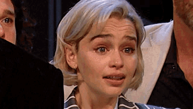 a close up of a woman 's face with a tear running down her cheek .