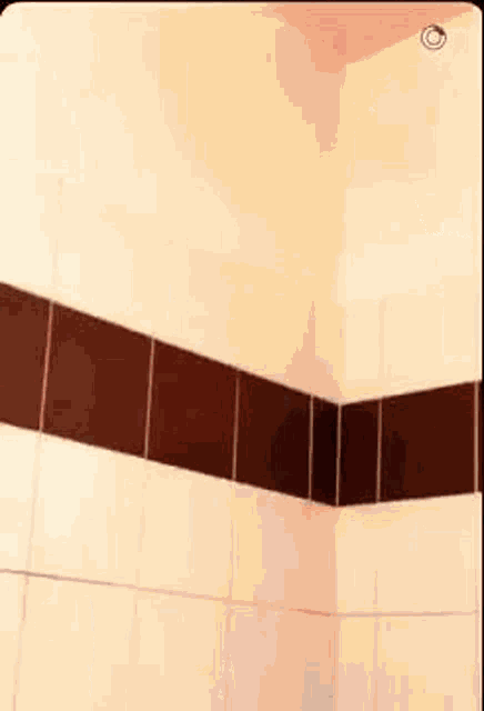 a blurry picture of a person standing in a bathroom .