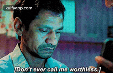 a man is looking at his cell phone and saying `` don 't ever call me worthless . ''