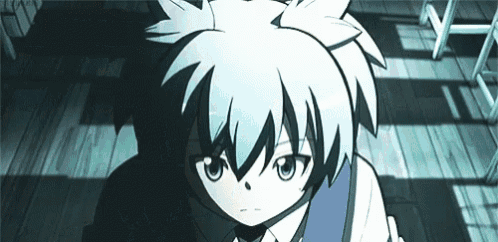a boy with white hair and blue eyes is standing on a wooden floor in a room .