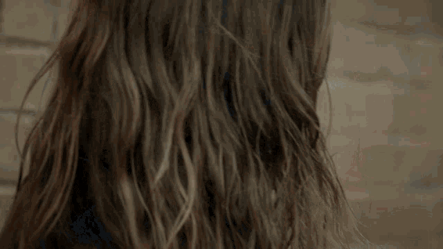a close up of a woman 's face with long hair .