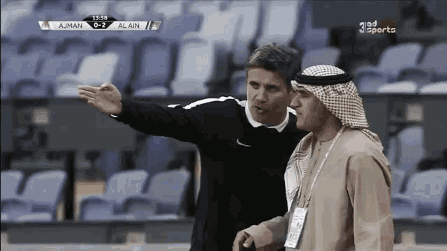 a soccer game is being played between ajman and alain at 11:59