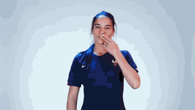 a woman wearing a blue shirt that says france on it