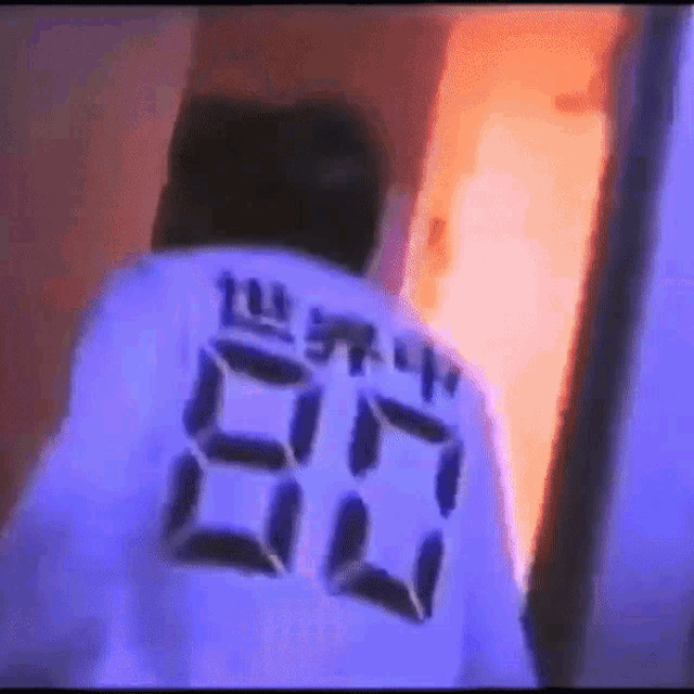 a person is wearing a shirt with the number 80 on it .