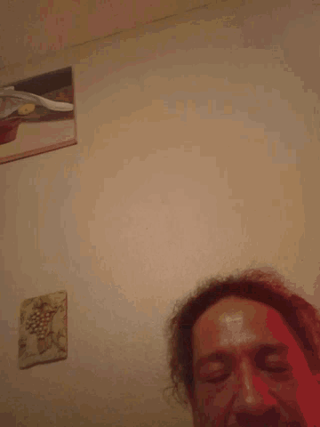 a man laying on a bed with a picture on the wall behind him that says ' i love you '
