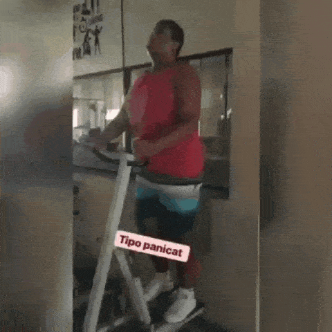 a man in a red tank top is standing on a type of machine called tipo panicat