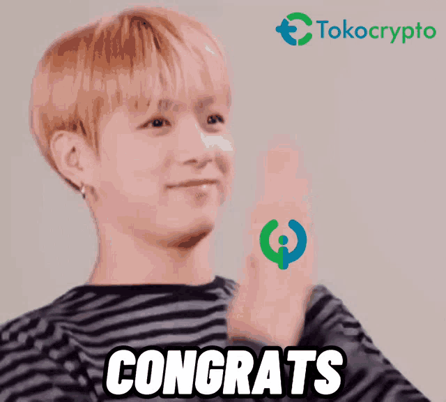 a man in a striped shirt says congrats with a tokocrypto logo in the background