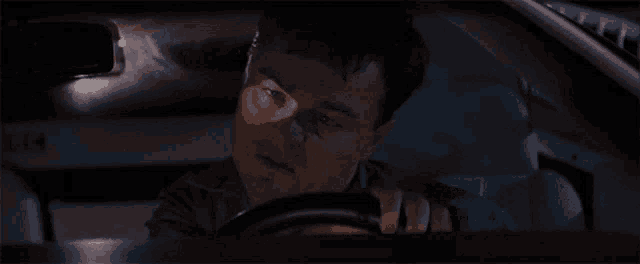 a man driving a car with a license plate that says t14