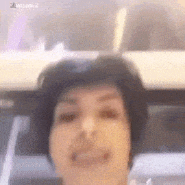 a close up of a woman 's face with a blurred background .