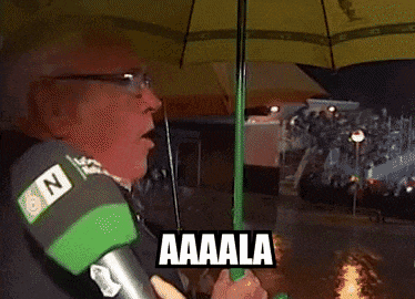 a man holding a green umbrella with the word aaala written on it