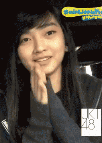 a girl with a jk48 logo on her sleeve