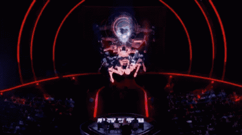 a dark room with a red light behind a stage