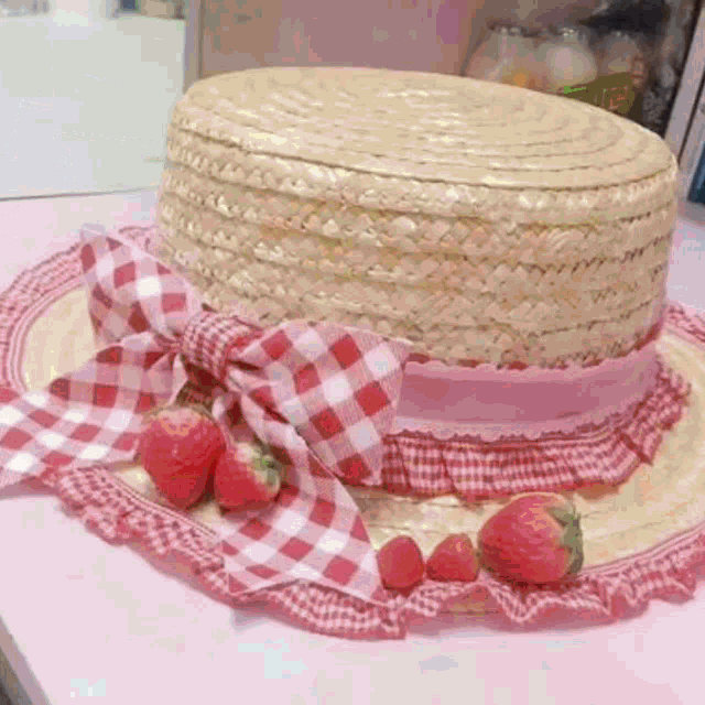 straw hat with strawberries on top of it