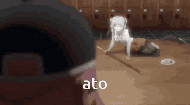 a girl is crawling on the floor with a stick and the word ato is visible