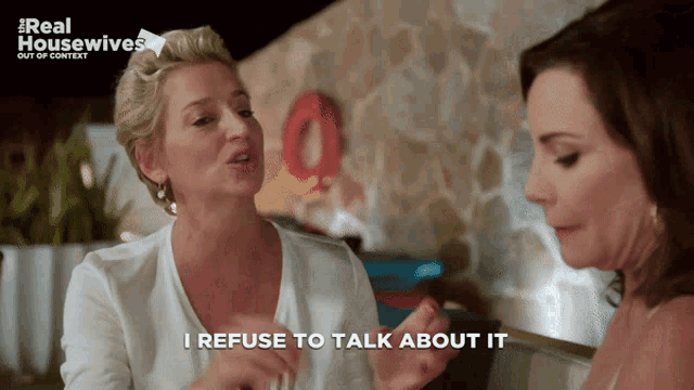 two women sitting at a table with the words i refuse to talk about it