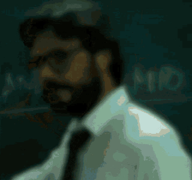 a man with a beard wearing glasses and a tie