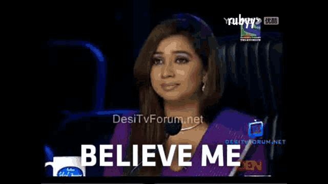 a woman sitting in front of a microphone with the words " believe me " above her
