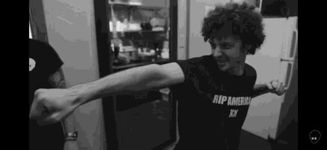 a man is wearing a shirt that says rip america xxx