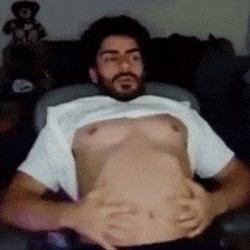 a man with a beard is laying down with his shirt off