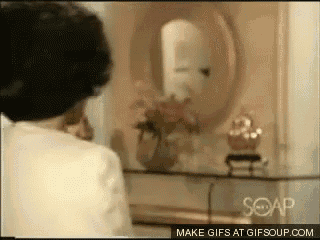 a woman is looking at herself in a mirror in a room with soap written on the bottom