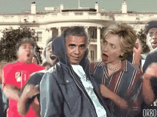 a group of people are standing in front of a white house with obama wearing a hoodie .