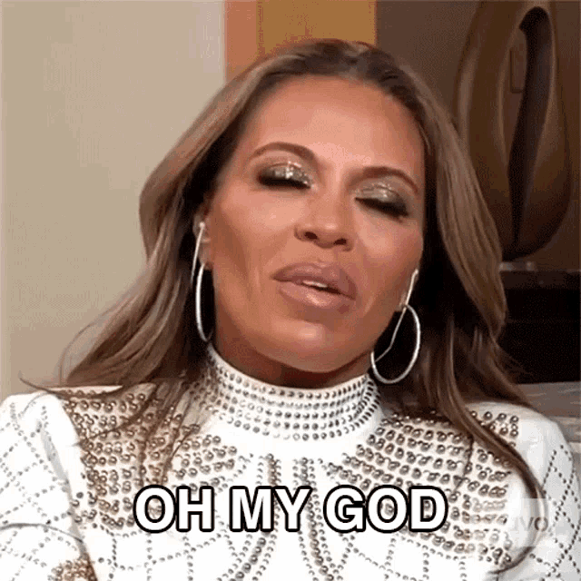 a woman wearing hoop earrings and a white dress says oh my god