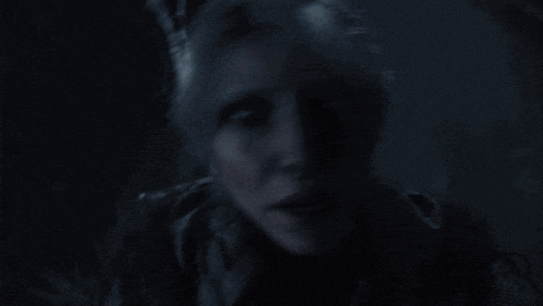 a woman 's face is visible in the dark