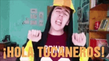 a girl wearing a hard hat and a shirt that says hola tocaneros
