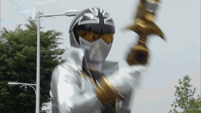 a man in a silver and black costume holding a hammer