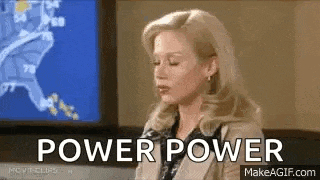 a woman is sitting in front of a television with the words `` power power '' written on her face .