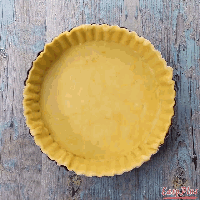 an empty pie crust on a wooden table with easy plans written on the bottom right