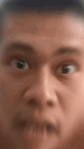 a close up of a man 's face with his mouth open