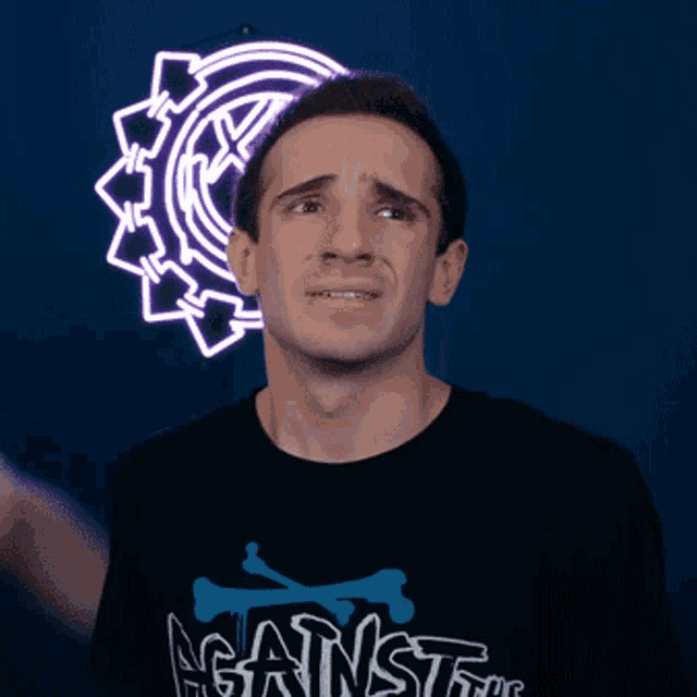 a man wearing a t-shirt that says against on it